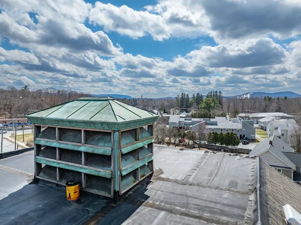 a view of a patio with table and chairs under an umbrella