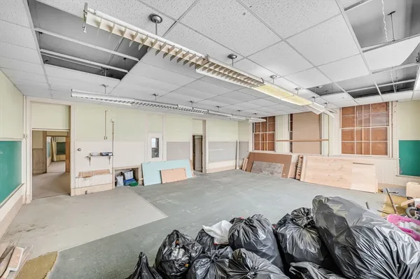 a large bedroom with a bed and a large mirror