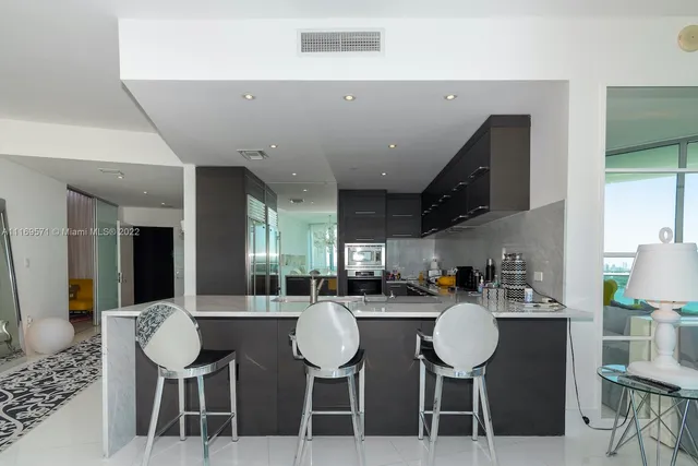 a kitchen with stainless steel appliances kitchen island granite countertop a sink and cabinets
