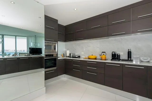 a kitchen with a sink a window and cabinets