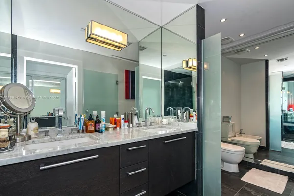 a bathroom with a toilet a sink and mirror