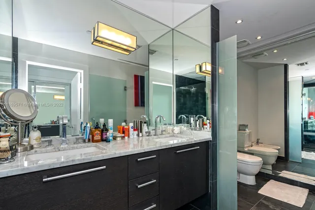 a bathroom with a toilet a sink and mirror