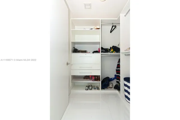 a bedroom with a workspace and a couch