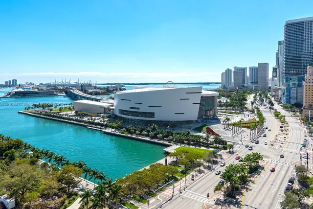 a dining room with furniture a chandelier and large windows