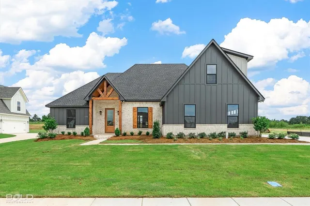 a front view of house with yard and green space