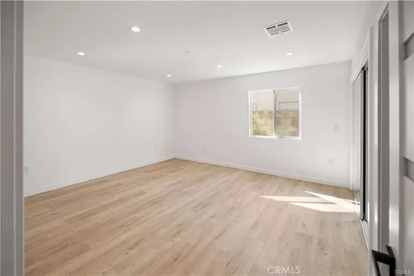 an empty room with windows and entrance