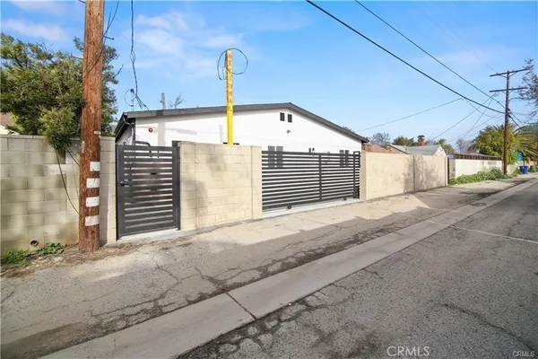 a kitchen with a sink cabinets and wooden floor