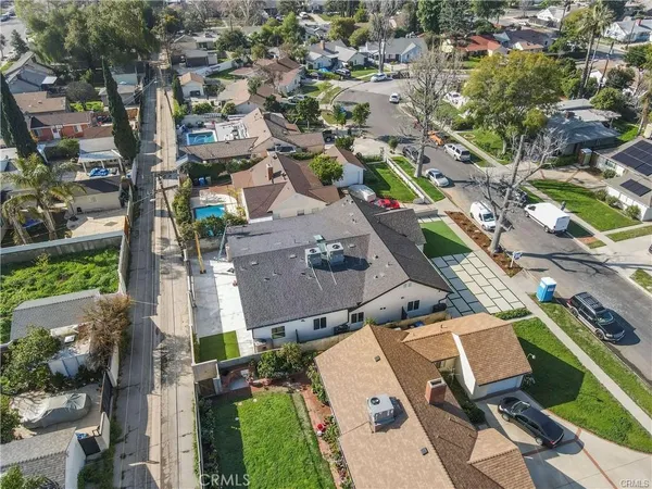 a utility room with stainless steel appliances and a couch