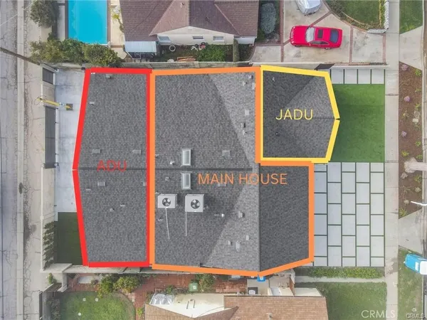 an aerial view of a tennis ground and a building in the background