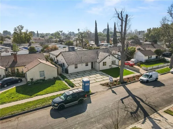 an aerial view of a house with garden space and street view