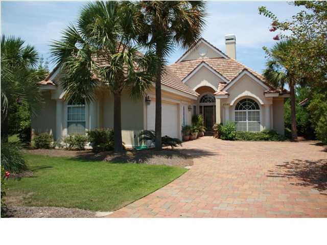 4595 Sailmaker Lane Destin, FL 32541 - Photo 1 of 14 a front view of a house with a garden and trees