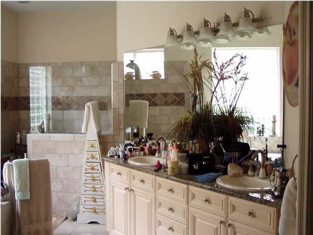 4595 Sailmaker Lane Destin, FL 32541 - Photo 5 of 14 a bathroom with a sink and a mirror
