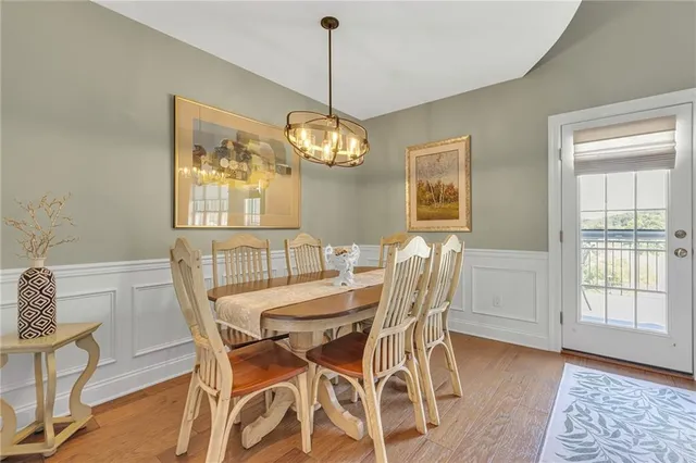 a view of a dining room with furniture wooden floor and chandelier