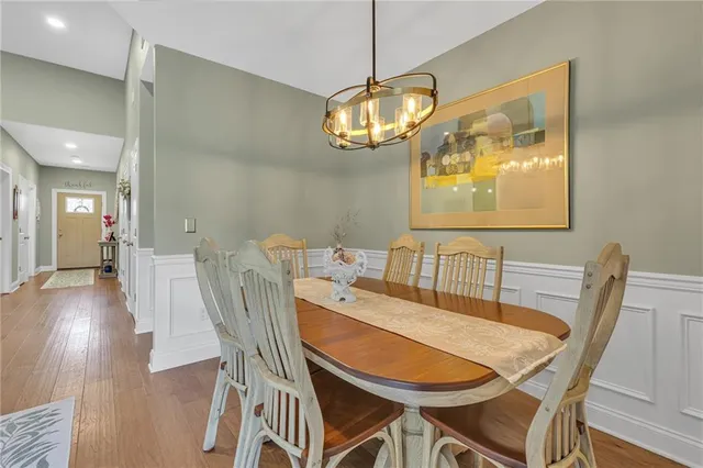 a view of a dining room with furniture wooden floor and chandelier