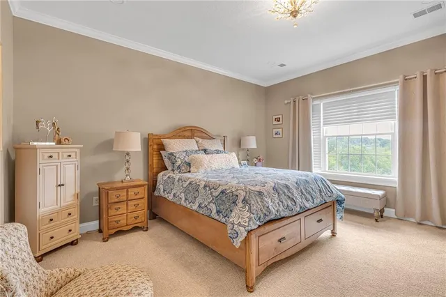 a spacious bedroom with a bed and a chandelier