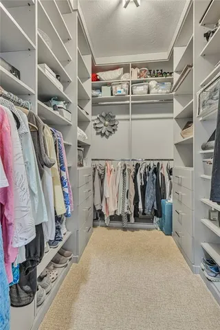 a view of walk in closet with clothes