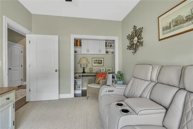 a living room with furniture and a baby crib