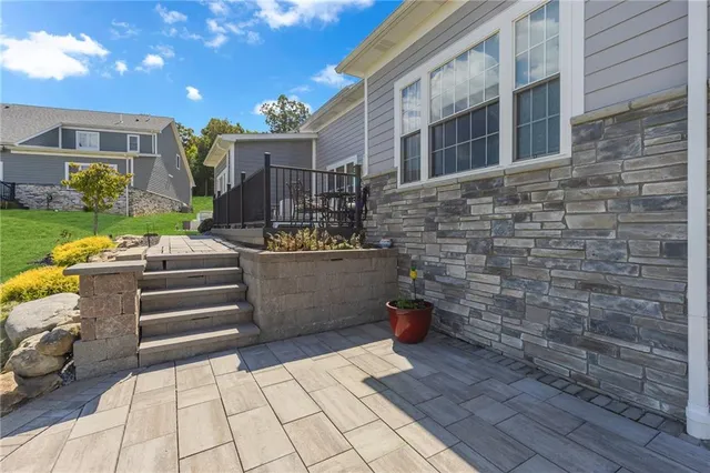 a view of a patio with table and chairs couches fire pit and wooden fence