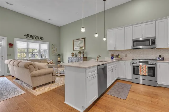 a kitchen with a white cabinets and window