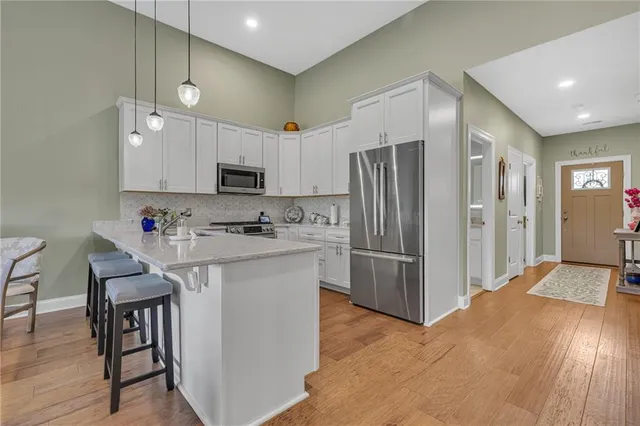 a kitchen with refrigerator cabinets and wooden floor