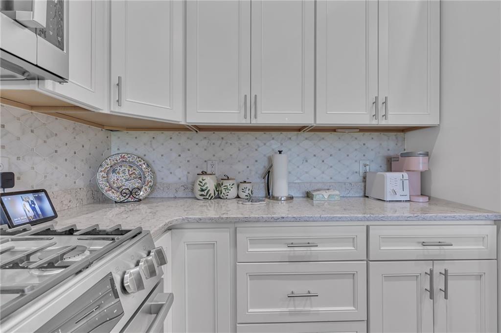 16 Pinehurst Place Beaver, PA 15009 - Photo 6 of 34 a kitchen with granite countertop white cabinets and a stove