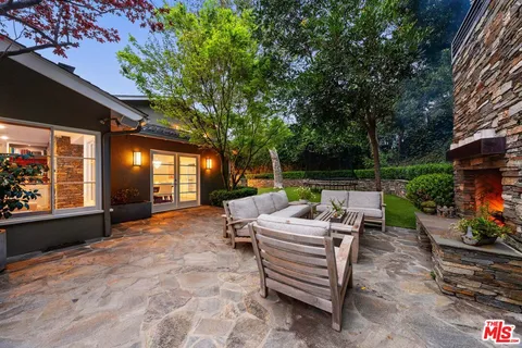 a view of a house with swimming pool and sitting area