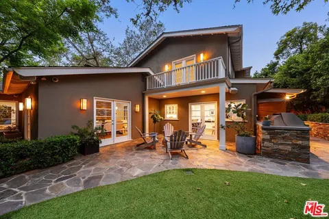 a view of a chairs and tables in the back yard of the house