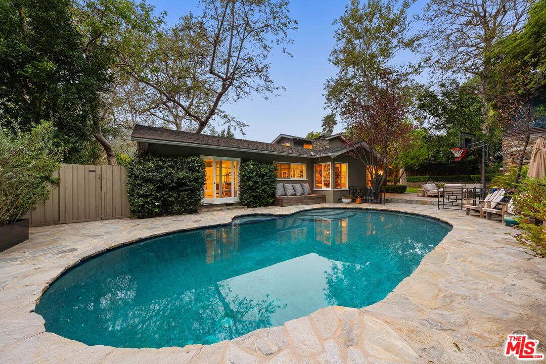3354 Mandeville Canyon Road Los Angeles, CA 90049 - Photo 22 of 63 a view of a house with swimming pool
