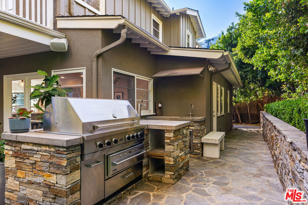 3354 Mandeville Canyon Road Los Angeles, CA 90049 - Photo 24 of 63 a view of a chairs and table in a patio
