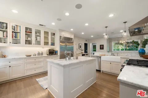a spacious bedroom with a bed and a cabinets