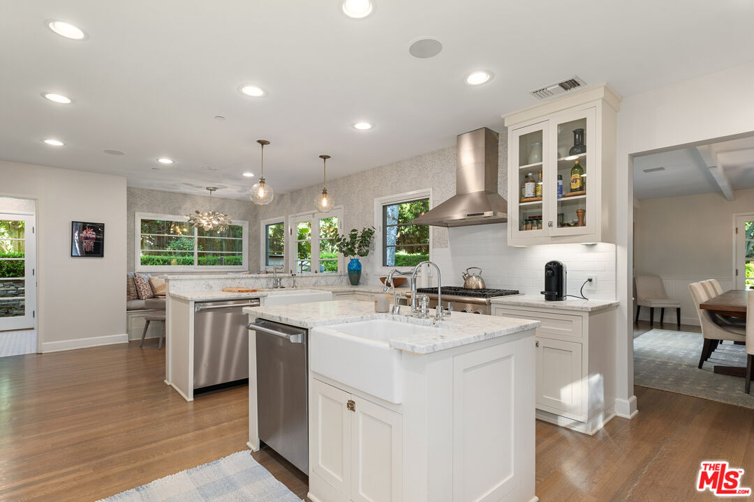 3354 Mandeville Canyon Road Los Angeles, CA 90049 - Photo 29 of 63 a kitchen with counter top space sink and living room view