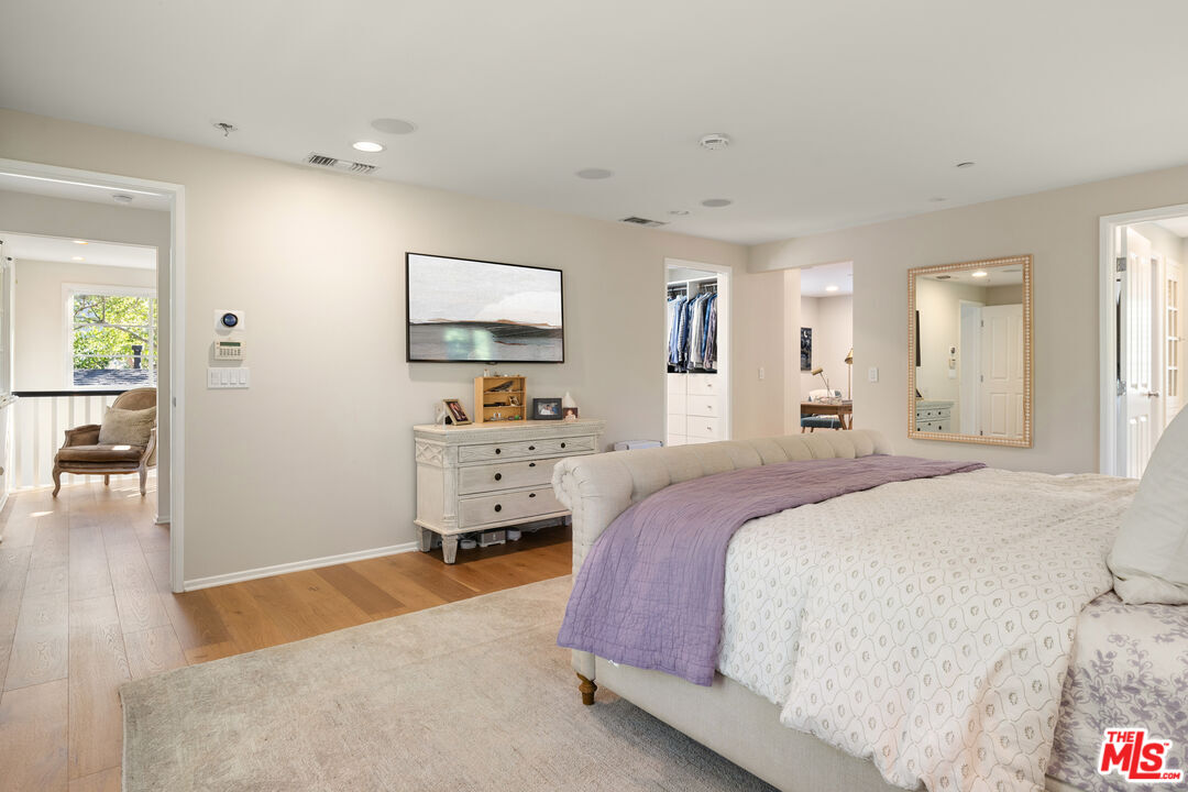 3354 Mandeville Canyon Road Los Angeles, CA 90049 - Photo 36 of 63 a spacious bedroom with a bed and a cabinets