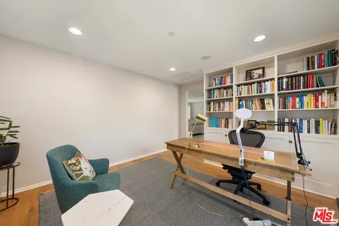 a bedroom with furniture toys and a large window