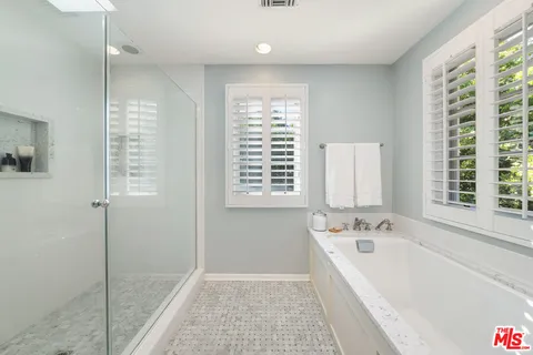 a bathroom with a bathtub and a shower