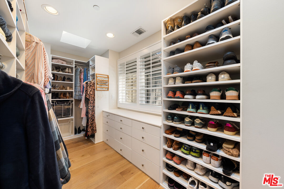 3354 Mandeville Canyon Road Los Angeles, CA 90049 - Photo 44 of 63 a view of walk in closet with clothes and shoes