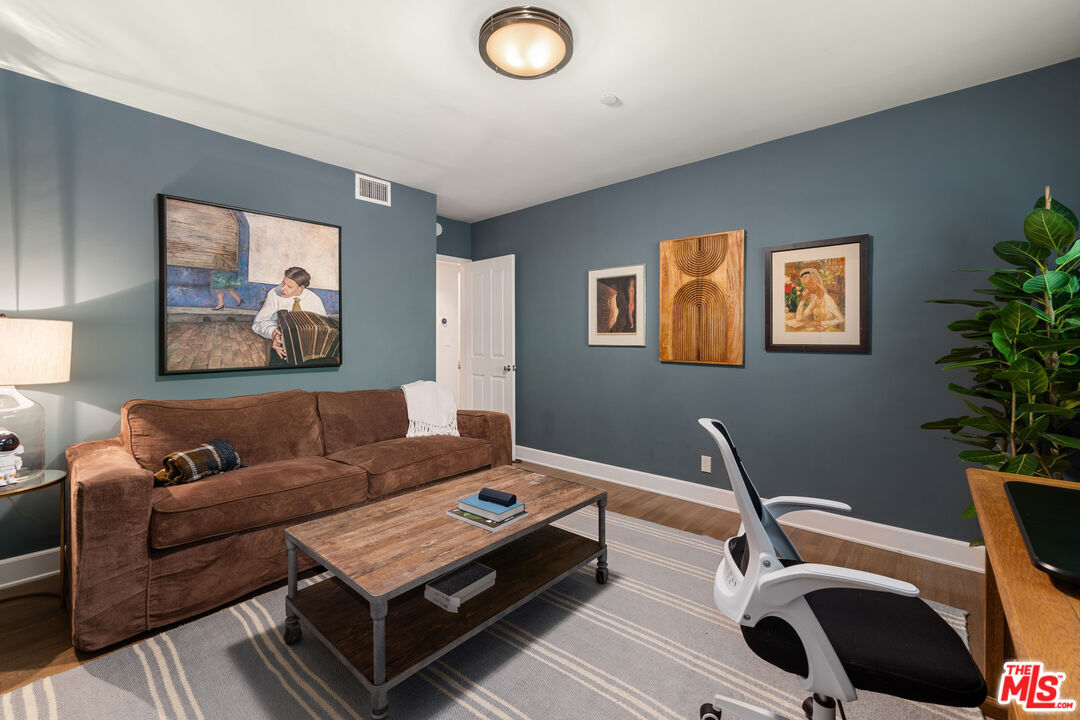3354 Mandeville Canyon Road Los Angeles, CA 90049 - Photo 48 of 63 a living room with furniture and a potted plant