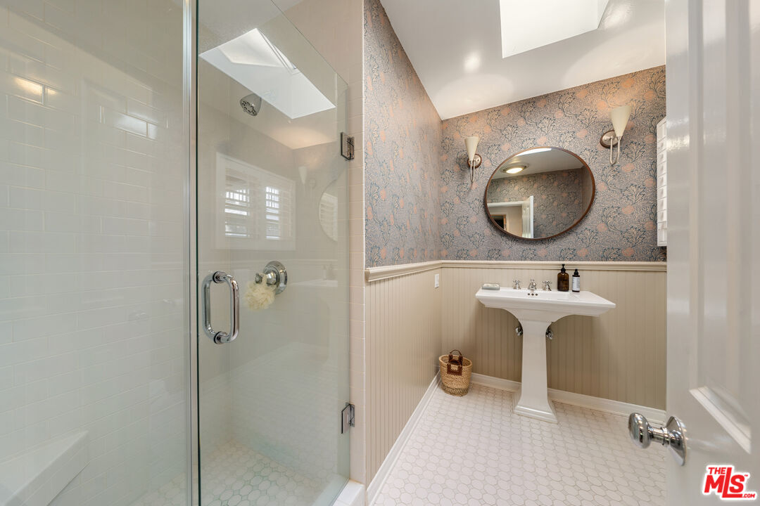 3354 Mandeville Canyon Road Los Angeles, CA 90049 - Photo 49 of 63 a bathroom with a sink and a mirror