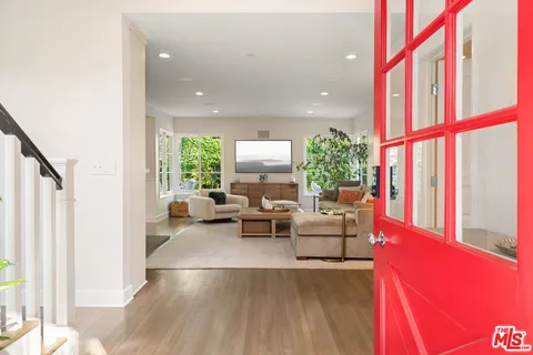 a view of entryway with wooden floor and stairs