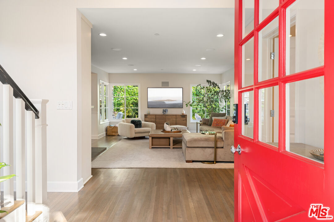 3354 Mandeville Canyon Road Los Angeles, CA 90049 - Photo 5 of 63 a living room with furniture and a floor to ceiling window