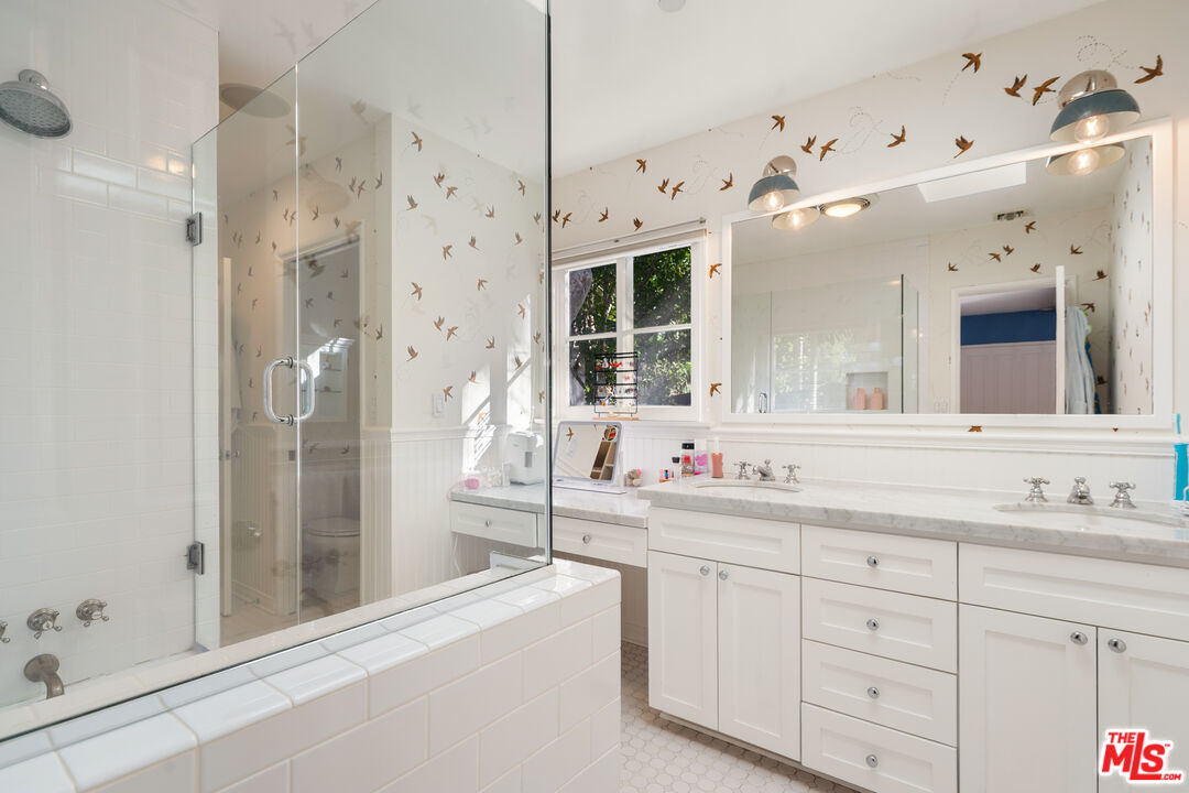 3354 Mandeville Canyon Road Los Angeles, CA 90049 - Photo 52 of 63 a bathroom with a sink mirror and a shower
