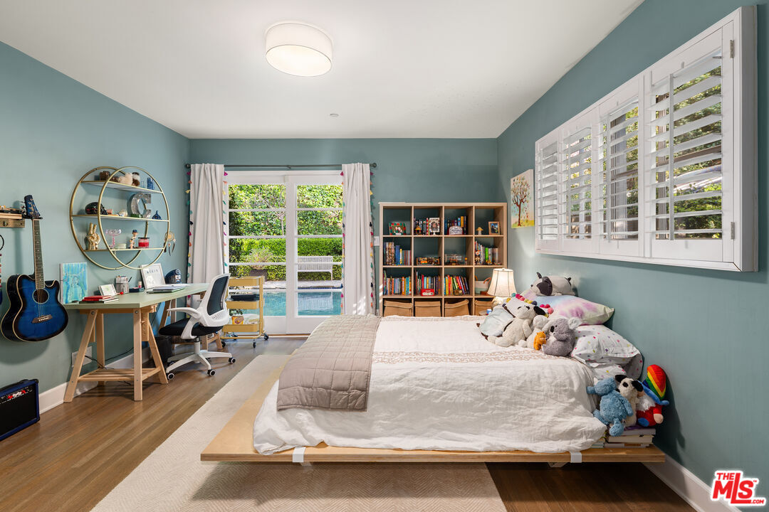 3354 Mandeville Canyon Road Los Angeles, CA 90049 - Photo 54 of 63 a bedroom with furniture and a large window