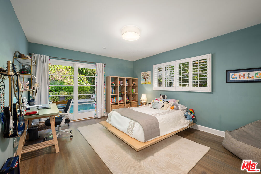 3354 Mandeville Canyon Road Los Angeles, CA 90049 - Photo 56 of 63 a bedroom with a bed and large windows