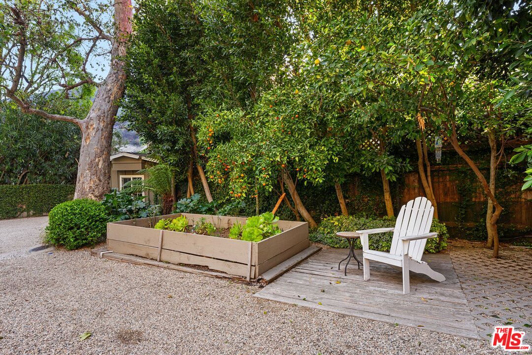 3354 Mandeville Canyon Road Los Angeles, CA 90049 - Photo 62 of 63 a view of a chair and table in the garden