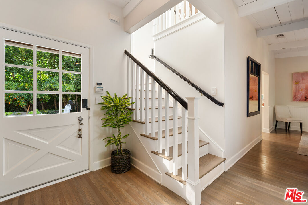 3354 Mandeville Canyon Road Los Angeles, CA 90049 - Photo 7 of 63 a view of entryway with wooden floor and stairs