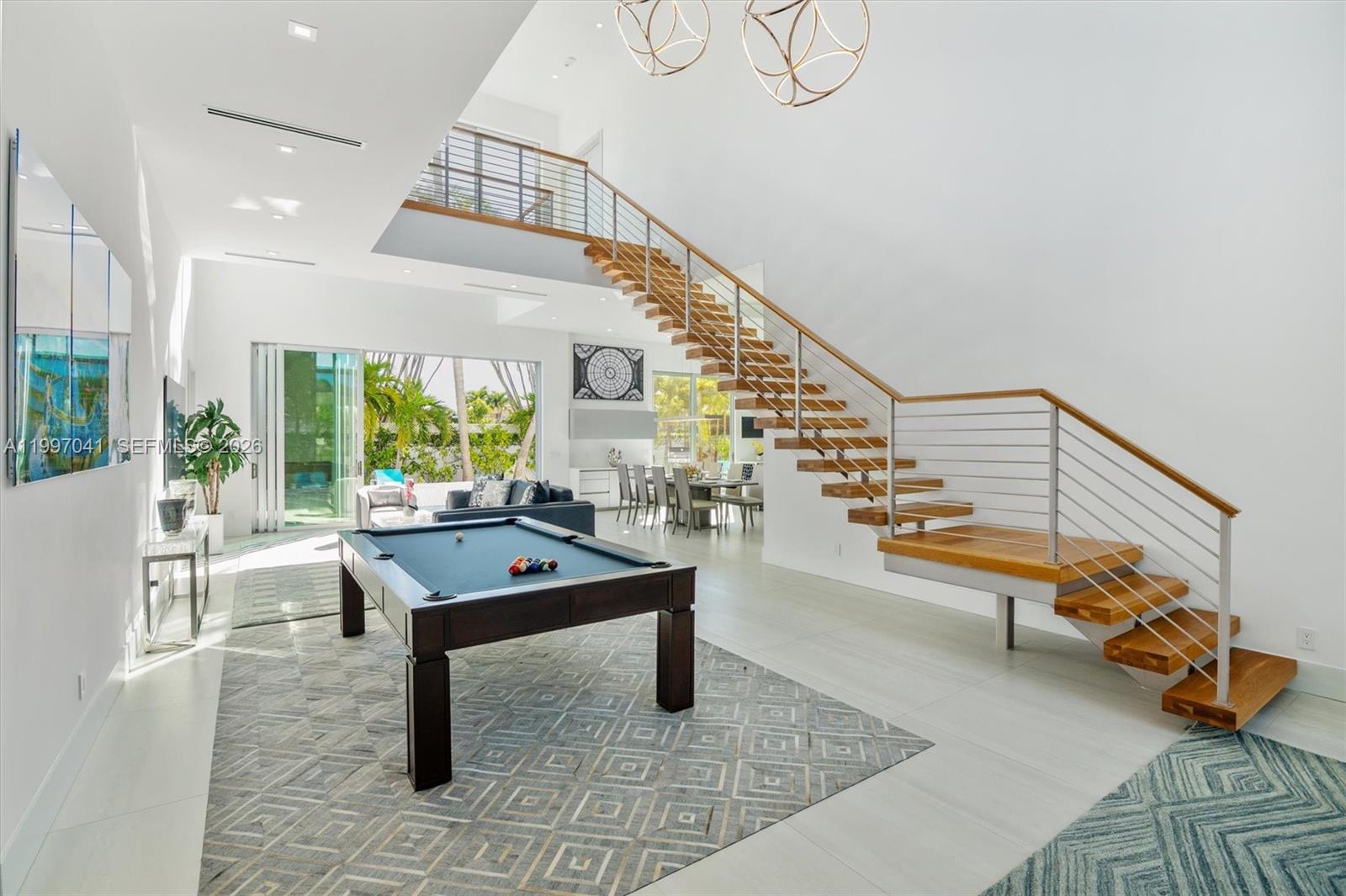 2628 Marcinski Road Jupiter, FL 33477 - Photo 15 of 50 a room with lots of furniture and wooden floor