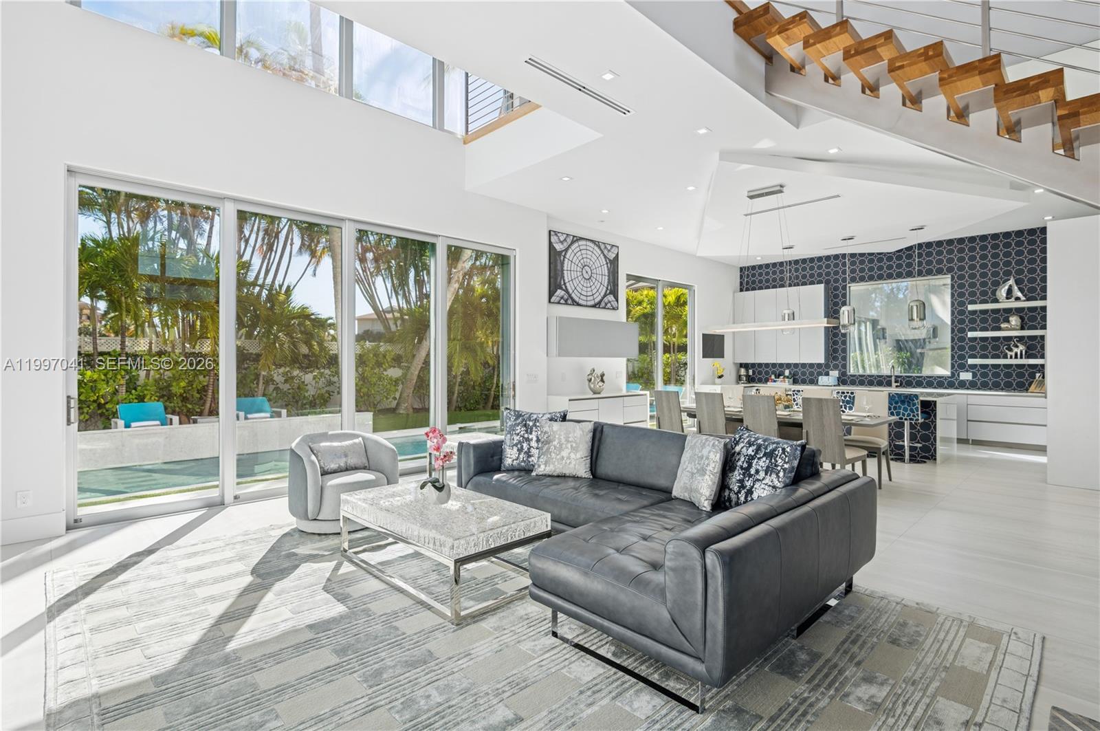 2628 Marcinski Road Jupiter, FL 33477 - Photo 16 of 50 a living room with furniture and large windows