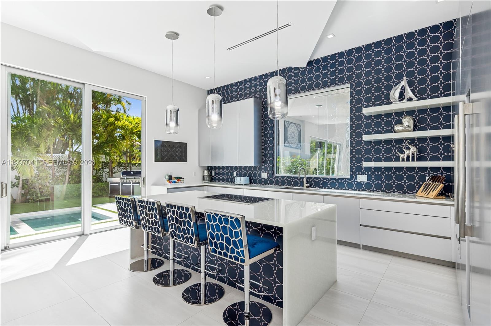 2628 Marcinski Road Jupiter, FL 33477 - Photo 19 of 50 a kitchen with a sink and chairs