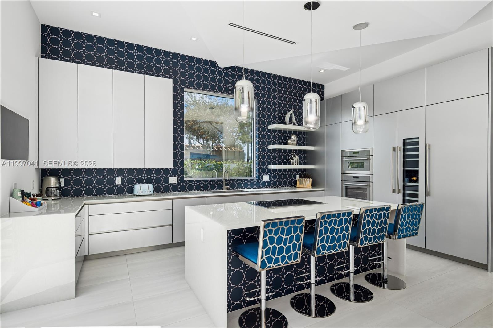 2628 Marcinski Road Jupiter, FL 33477 - Photo 20 of 50 a kitchen with a table chairs sink and cabinets