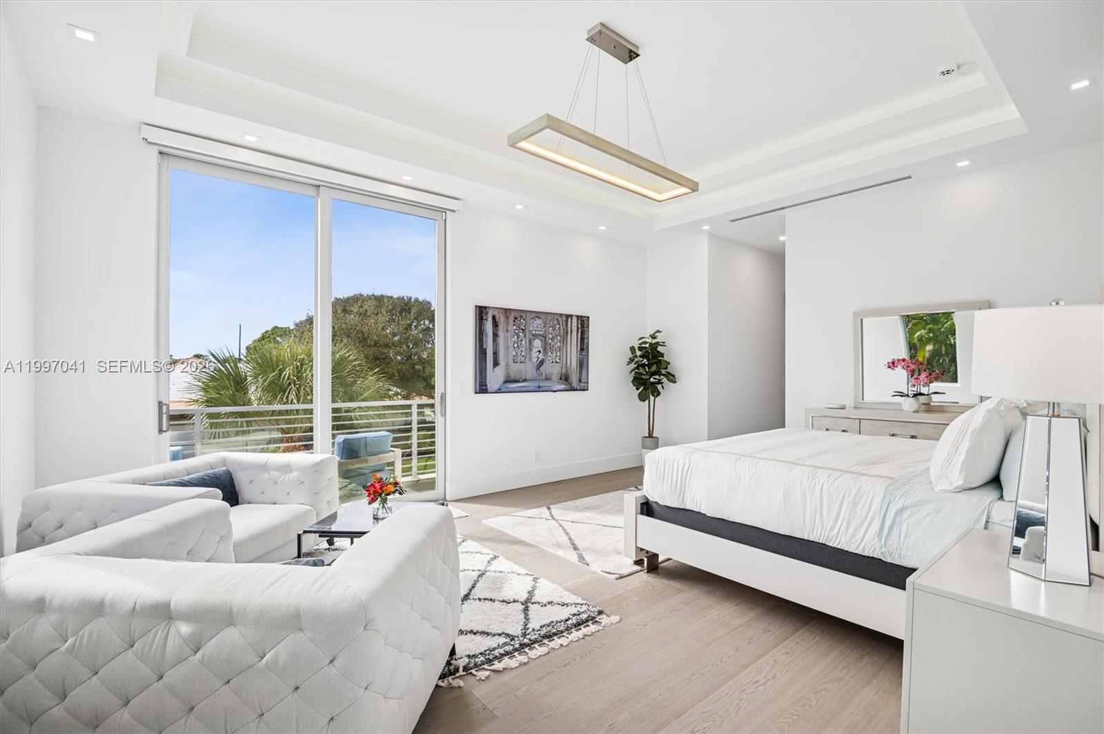 2628 Marcinski Road Jupiter, FL 33477 - Photo 24 of 50 a bedroom with a large bed and a large window