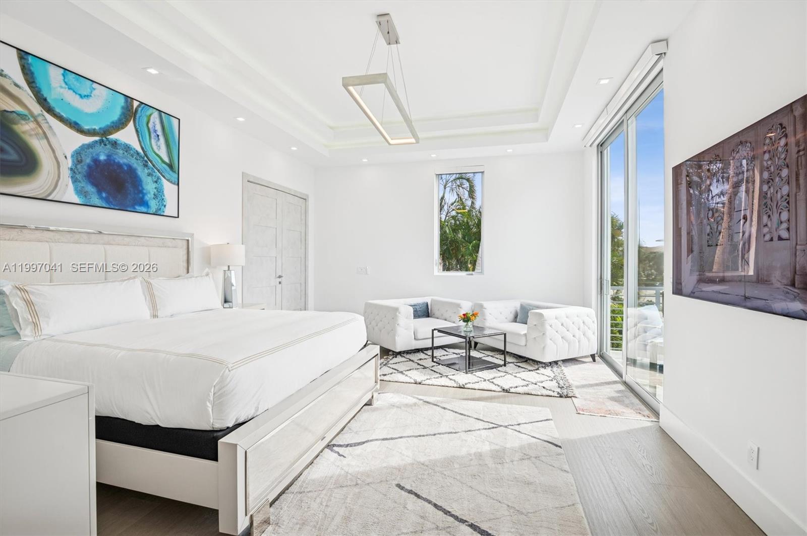 2628 Marcinski Road Jupiter, FL 33477 - Photo 25 of 50 a bedroom with a bed and wooden floor